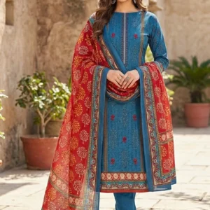 Full-length view of a woman wearing a premium blue printed cotton kurta with a contrasting red printed dupatta and blue churidar pants.